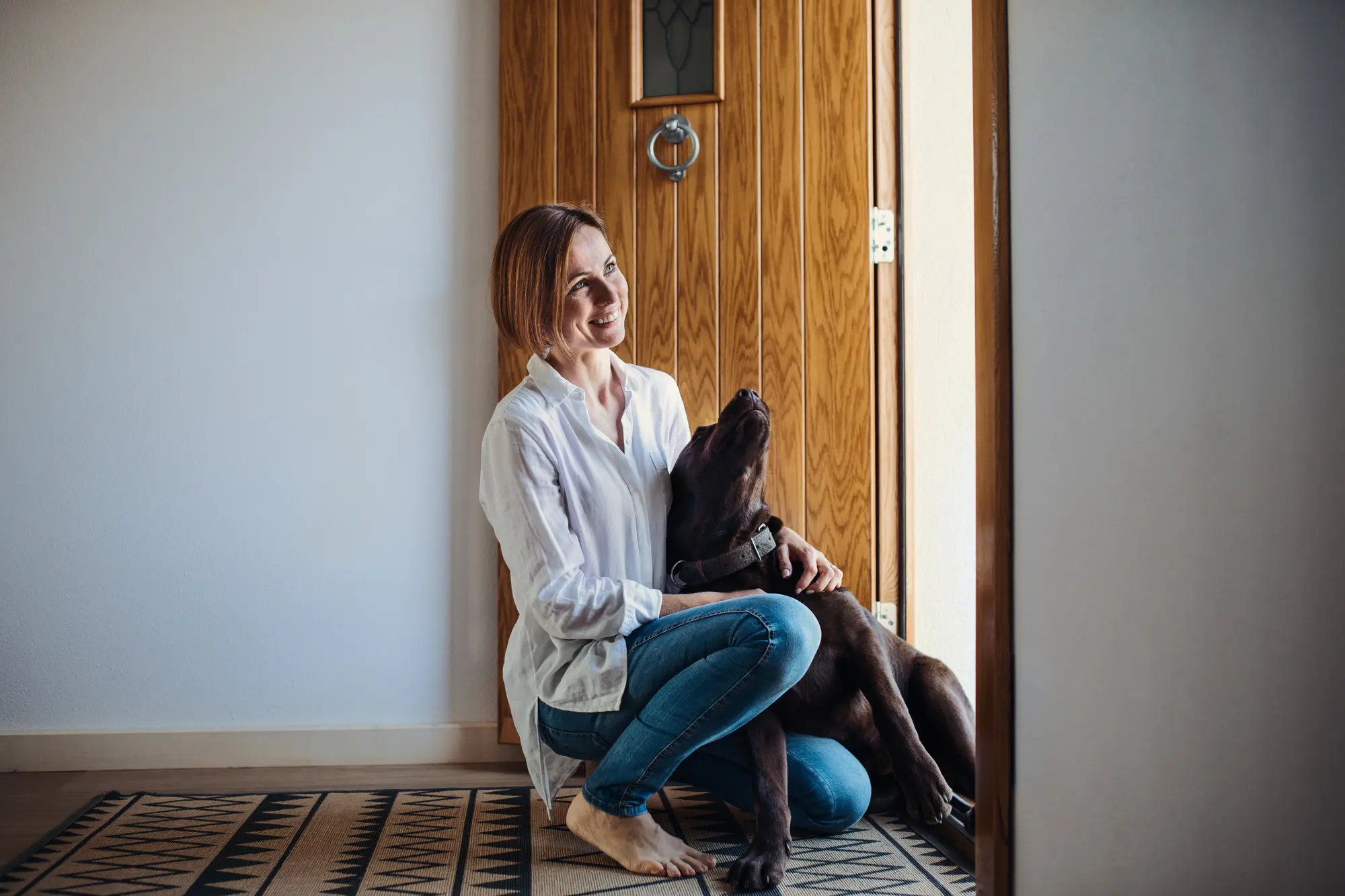 Woman dog in front of door